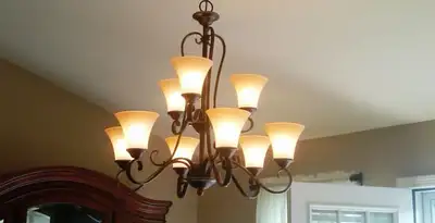 Classic ceiling chandelier installation with warm lighting in Bradenton, FL