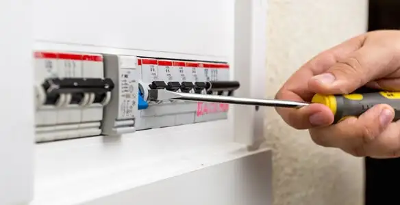 electrical panel upgrade service showing technician adjusting circuit breakers during system upgrade in Bradenton, FL