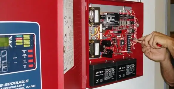 fire alarm installation service showing technician configuring fire alarm control panel in Bradenton, FL