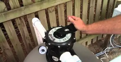 pool pumps service showing professional adjustment of pool pump control system in Bradenton, FL
