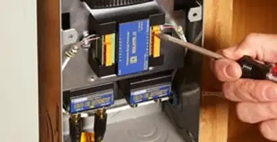 Whole home surge protection device being installed by a licensed electrician to protect electrical systems in Bradenton, FL